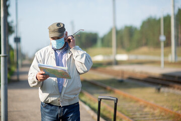 Senior elderly man looking at map on traveling journey during pandemic