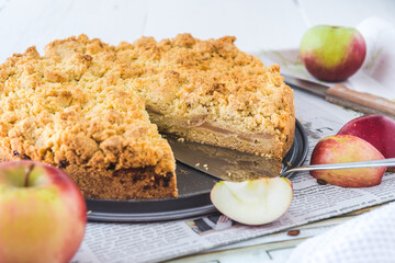 Apple pie with sprinkles, apple crumble, on a tray on white background