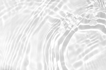 de-focused. Blurred desaturated transparent clear calm water surface texture with splashes and bubbles. Trendy abstract nature background. White-grey water waves in sunlight. Copy space.