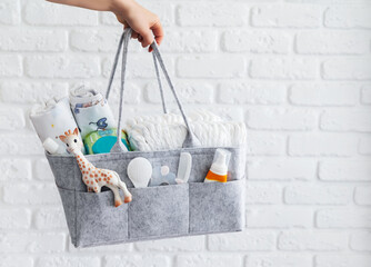 Mothers bag with toy, diapers and accessories on white background. - 382089773