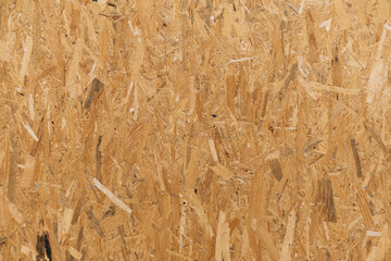 Oriented strand board. A close-up of a board made of pressed sawdust.