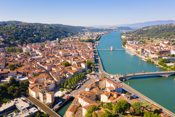 General view of Vienne city on banks of Rhone river surrounded by high hills in sunny summer day, Isere, France - obrazy, fototapety, plakaty