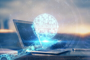 Double exposure of blockchain theme hologram and table with computer background. Concept of bitcoin crypto currency.