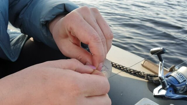 the fisherman fastens the Wobbler with a carbine to the fishing line, trolling fishing