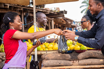 african people buying and selling in a local market