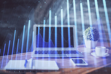 Forex market chart hologram and personal computer background. Double exposure. Concept of investment.