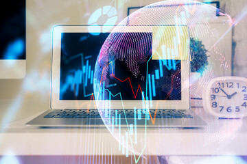 Double exposure of chart and financial info and work space with computer background. Concept of international online trading.