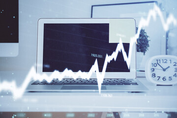 Forex Chart hologram on table with computer background. Multi exposure. Concept of financial...