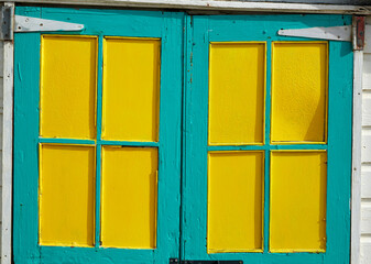 Multi-coloured windows of beach hut in Saunton Sands, North Devon.