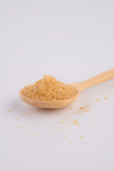 brown sugar in a wooden spoon isolated on white