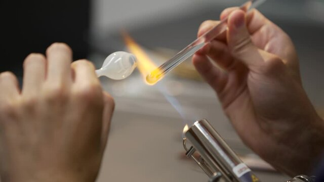 Glass eye prosthetic production (Ocular prosthesis). Burning Glass on a burner. 4K Video