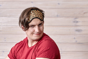 Young handsome caucasian man with weird face expression, sly smiling, flirting, ridiculous mimic....