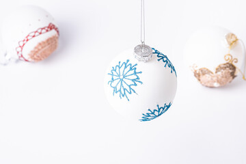 Christmas New Year composition. Gifts, white ball decorations on white background. Winter holidays concept. Angle view
