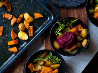 Home made roast vegetables with arugula and beetroot puree. Natural light.