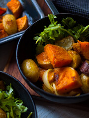 Home made roast vegetables with arugula and beetroot puree. Natural light.