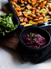 Home made roast vegetables with arugula and beetroot puree. Natural light.
