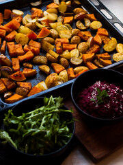 Home made roast vegetables with arugula and beetroot puree. Natural light.