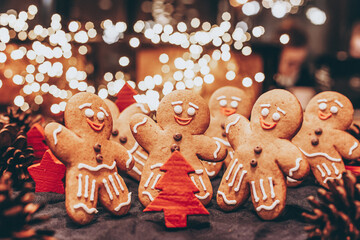 selective focus, vintage effect: Celebrating Christmas and New Year, a group of gingerbread men gathered in front of a Christmas tree