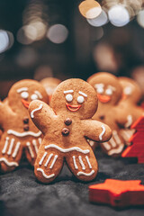 Many Christmas cookies in the form of gingerbread men depicting people celebrating the New Year in the forest near the Christmas tree