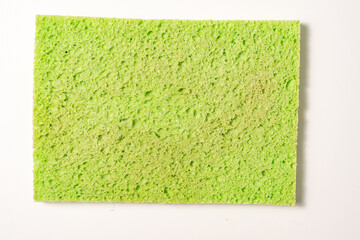 old used sponge for washing dishes on a light background