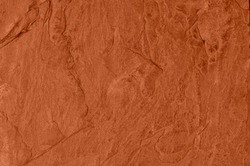 Saturated dark orange brown colored low contrast Concrete textured background with roughness and irregularities. 2021, 2022 color trend.