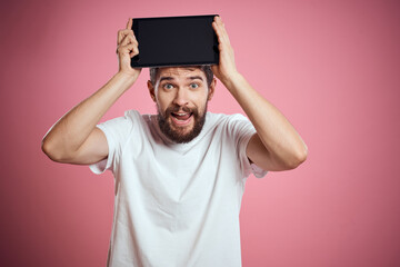 Man advertises a tablet on a pink background codes Space cropped view of emotions white t-shirt model new technologies