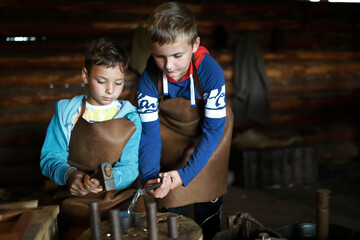Boys make coin in forge