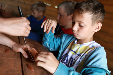 Boys making mascot with runes