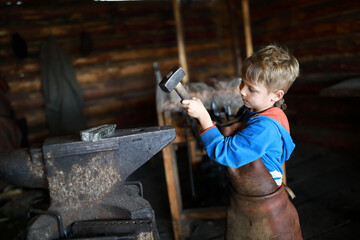 Child hits anvil with hammer
