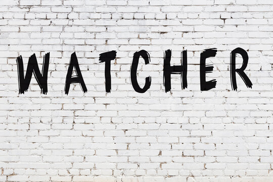 White wall with black paint inscription watcher on it