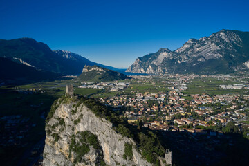 Fototapeta na wymiar Arco Medieval Castle on the top of the rock. Flying on drone, aerial view of Arco Castle ruins, Lake Garda. Italy.