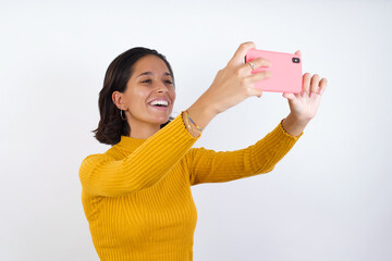Young hispanic girl with short hair wearing casual yellow shirt isolated over white background...