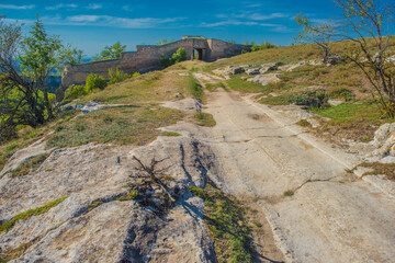 the remains of a medieval fortress city (according to other sources - a monastery) Tepe-Kermen, covering the upper part of the mountain in several tiers
