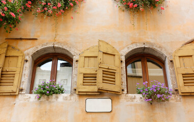 Fototapeta na wymiar Exterior of a Historic Building Decorated with Flowers