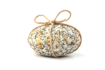 Sea smooth oval pebble with bow isolated on white background. Round pebble stone from Baltic sea beach. Gift, decoration or Easter concept.