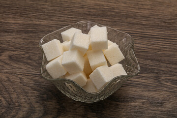 Refined white sugar cubs in the bowl