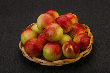Sweet small nectarines in the basket