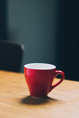Red espresso cup with coffee on wooden table. High quality photo