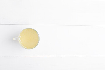 Homemade bone broth with leek in glass cup