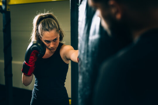 woman practice boxing with her personal trainer