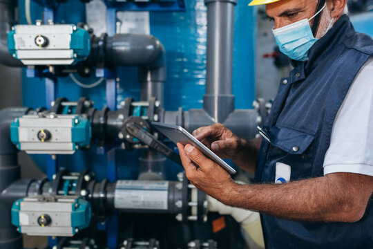 Industry Worker Checking Chemical Water Treatment Equipment