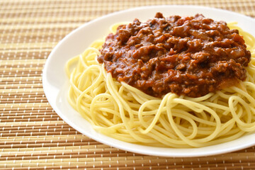 Spaghetti Bolognese with minced beef, onion, chopped tomato, garlic, olive oil, stock cube, tomato puree and Italian herb. Traditional Italian food.