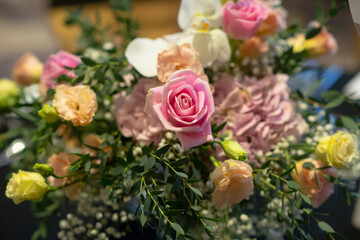 Pink rose over bunch of colorful flower
