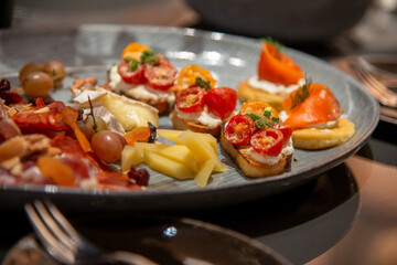 close up of bruschetta on variety of  italian cold cut board