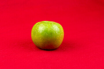 Green apples on a red background