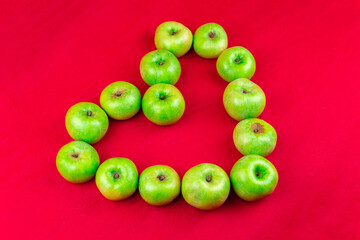 Green apples on a red background