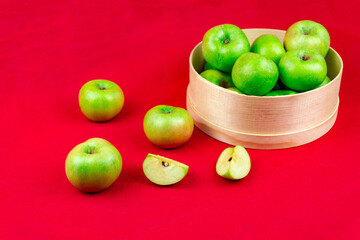 Green apples on a red background