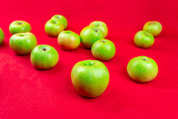 Green apples on a red background