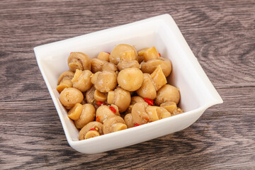 Pickled champignons in the bowl