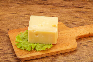 Emmental cheese over wooden board